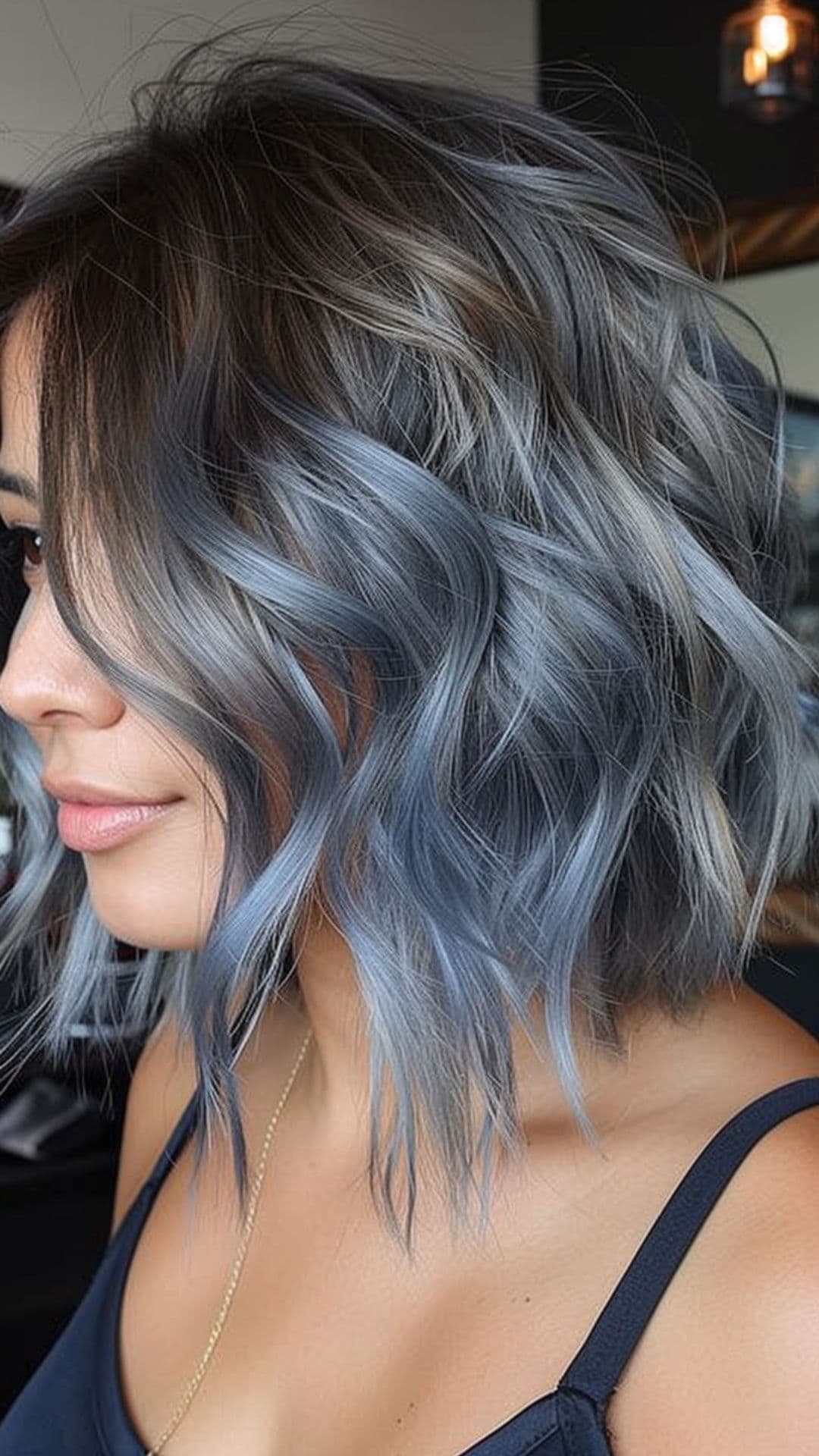 A woman modelling a steel blue ombre hair.