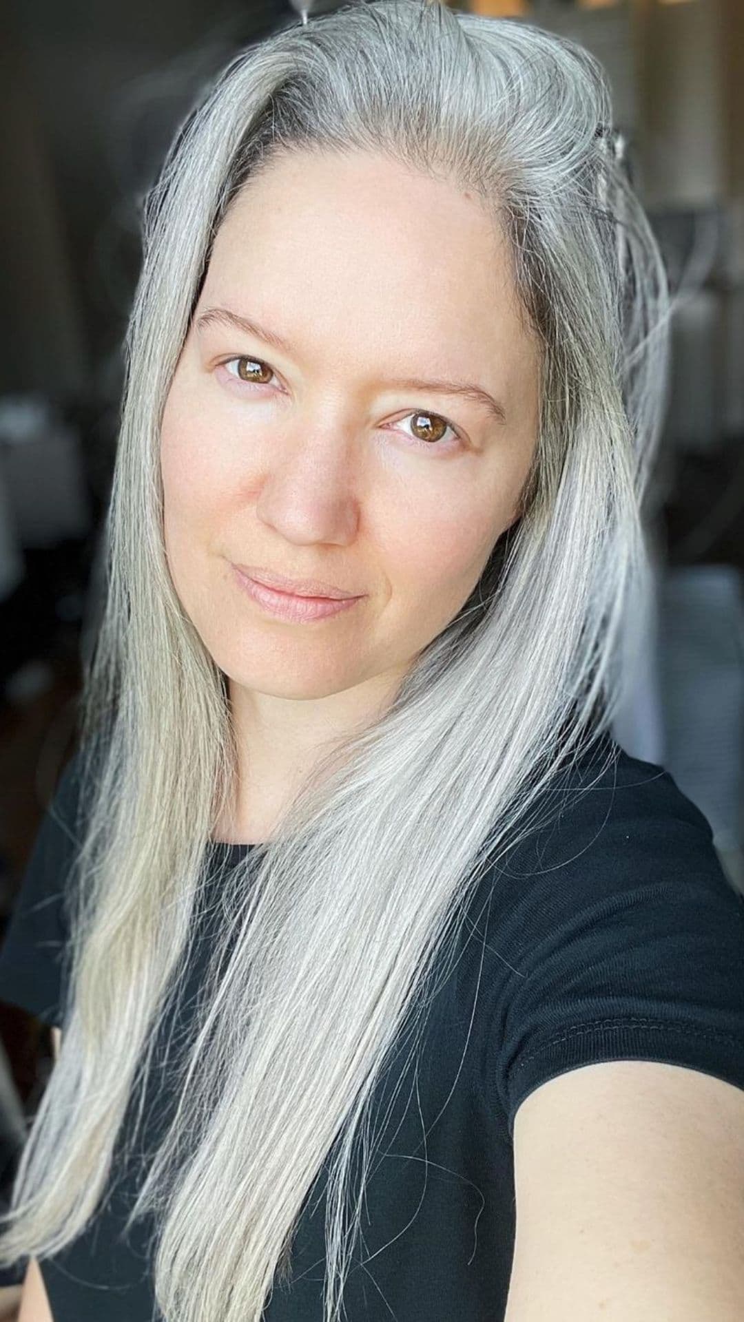 An older woman modelling a straight silver hair.