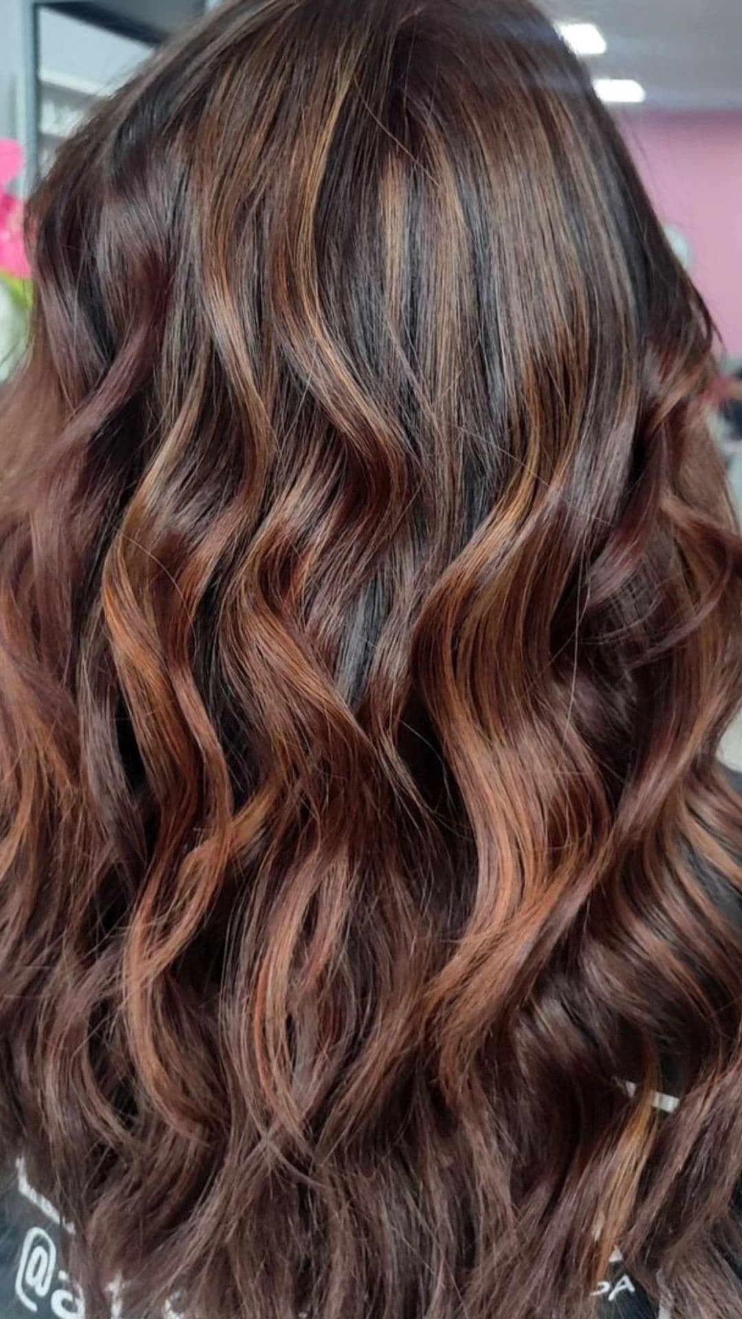 Wavy caramel balayage hairstyle with multi-toned highlights.