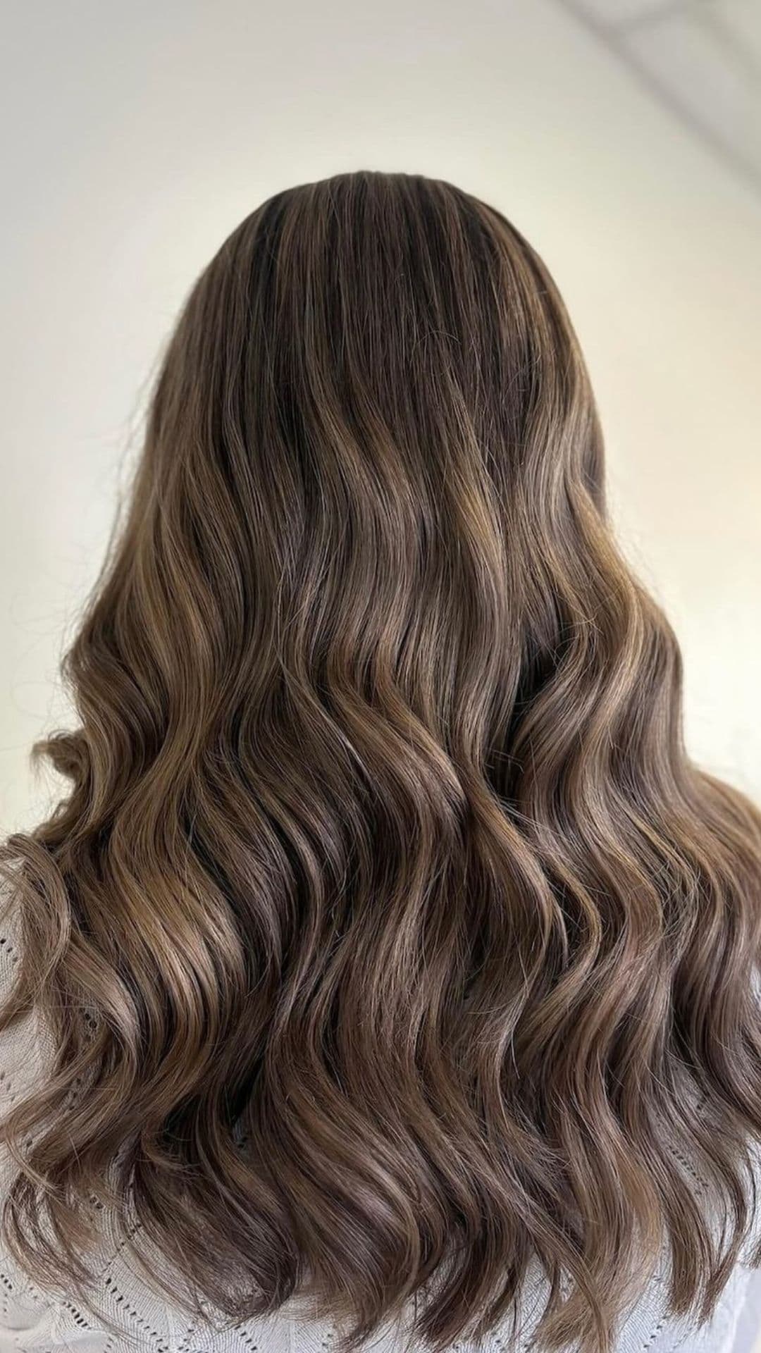 Mocha Balayage hairstyle with long, wavy hair shown from the back.