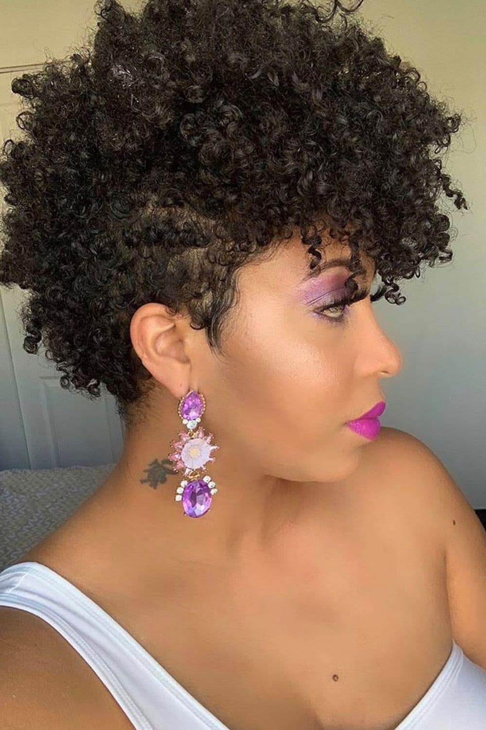 A woman with a black tapered frohawk.