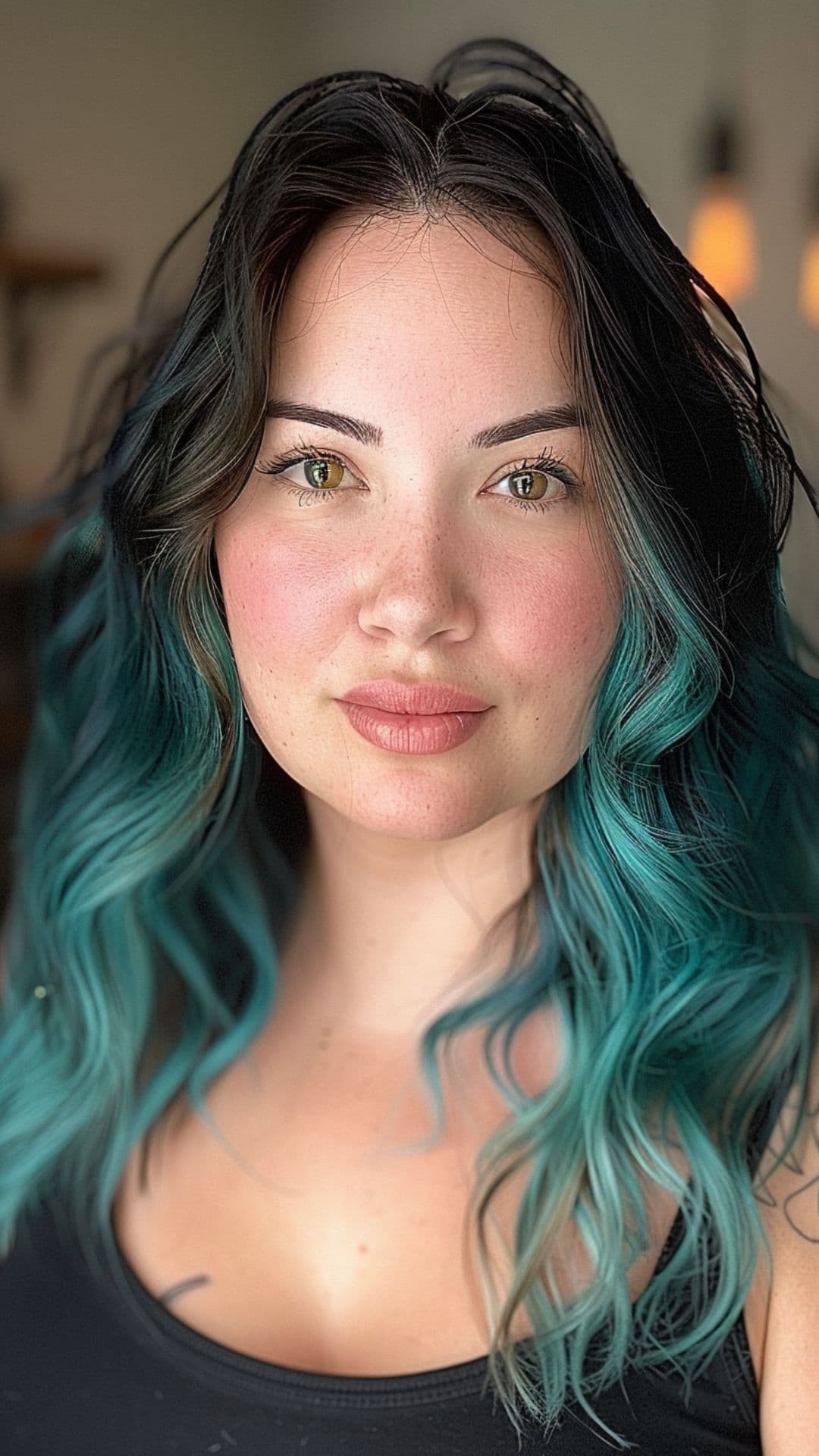 A woman modelling a black to turquoise ombre hair.