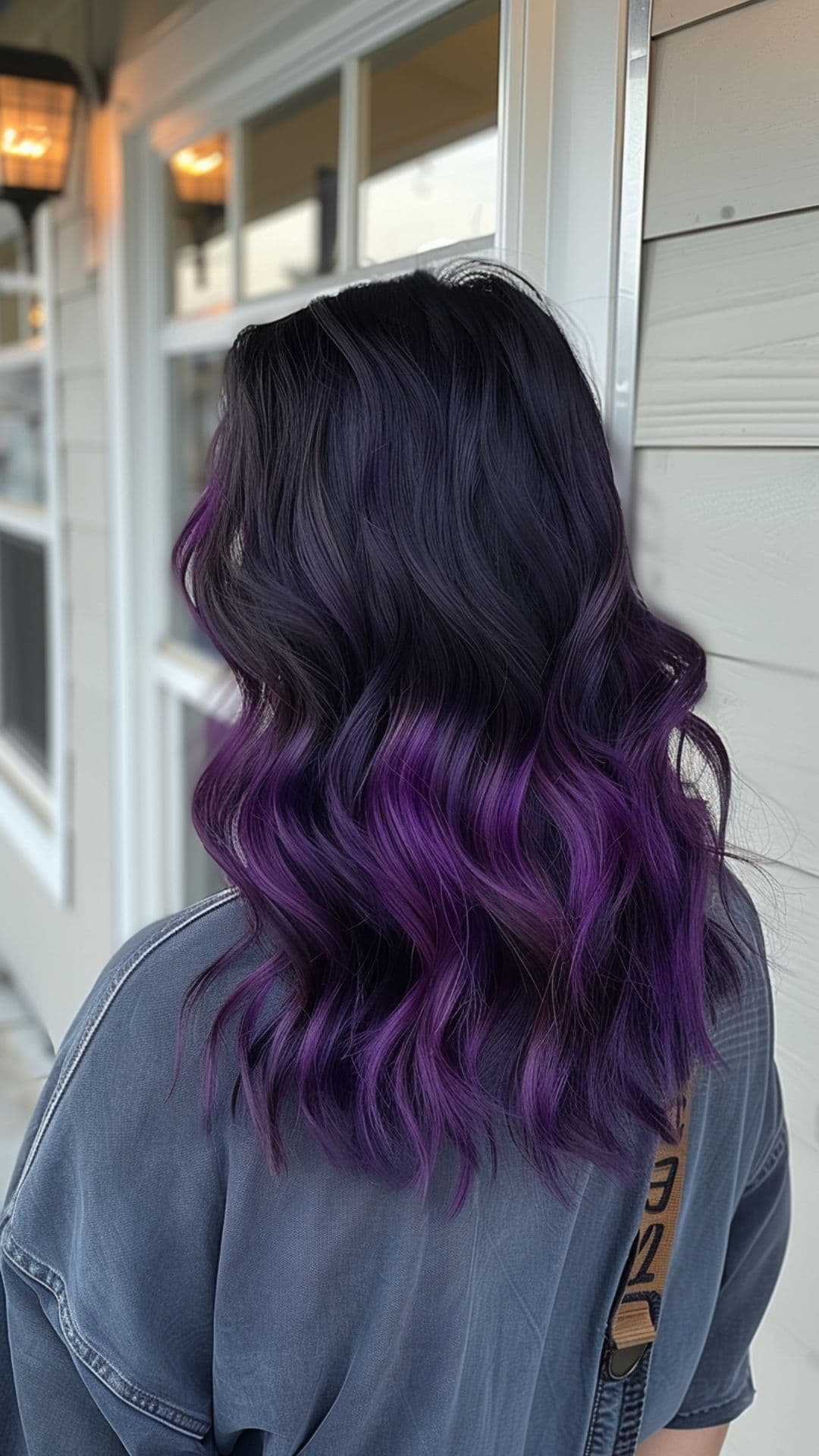 A woman modelling a black to velvet purple ombre hair.