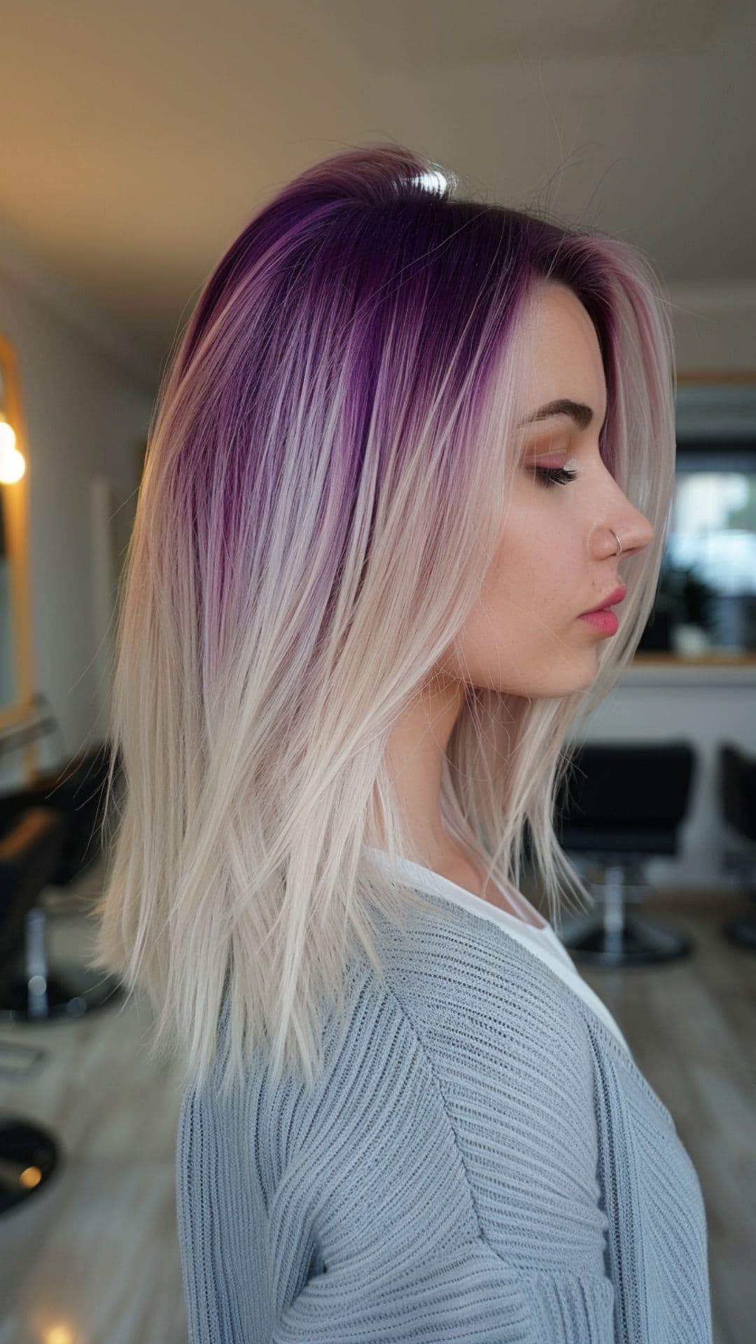 A woman modelling a violet to platinum ombre hair.