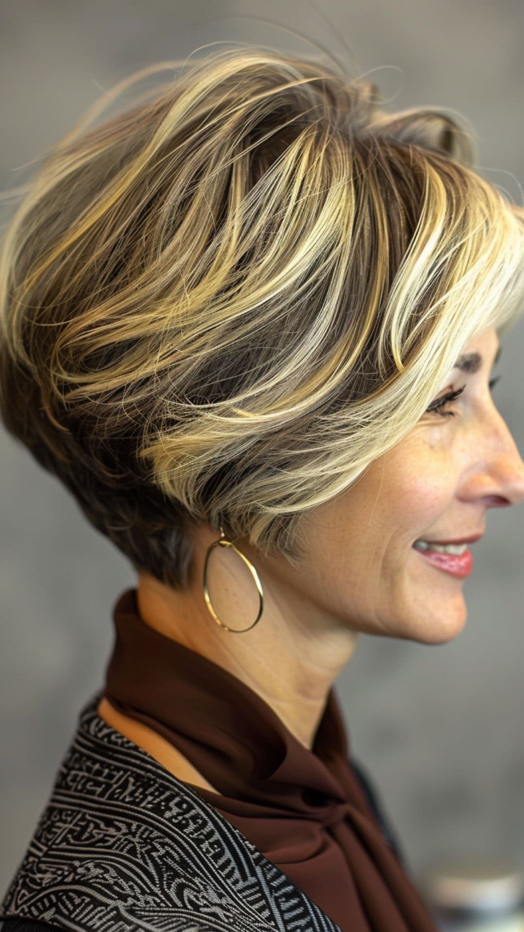 An old woman modelling a voluminous pixie bob hair.