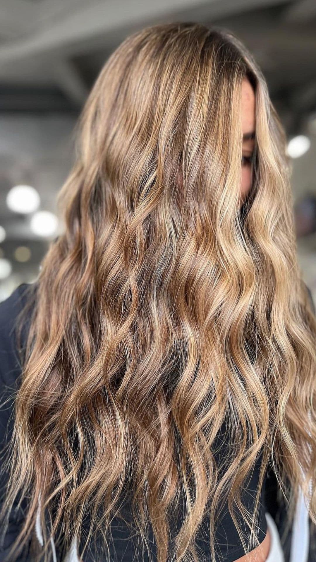 A woman modelling a beach bronze brunetter hairstyle.