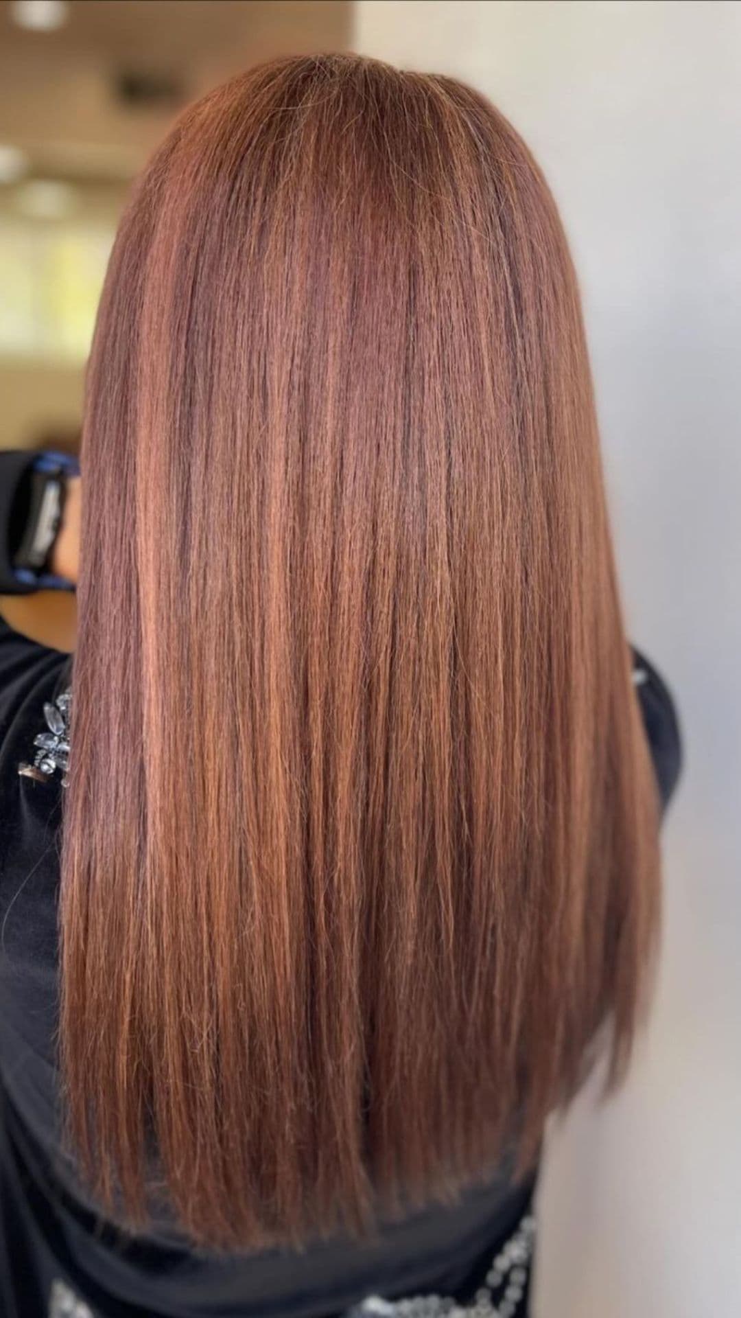 A woman modelling a blended reddish light brown hair.