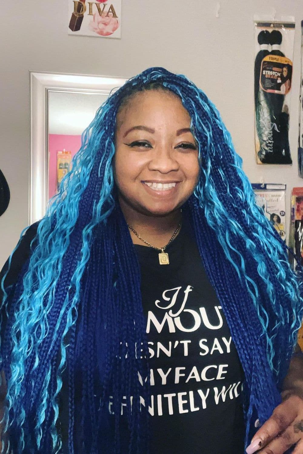 A woman with long blue goddess micro braids.