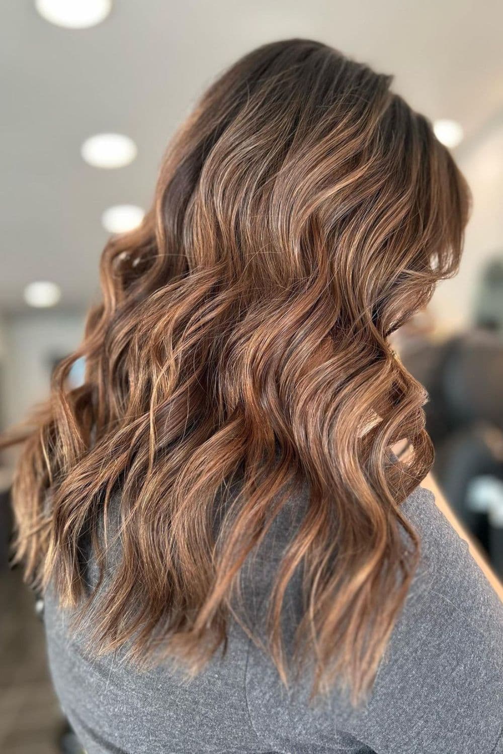 A woman with medium-length caramel balayage.