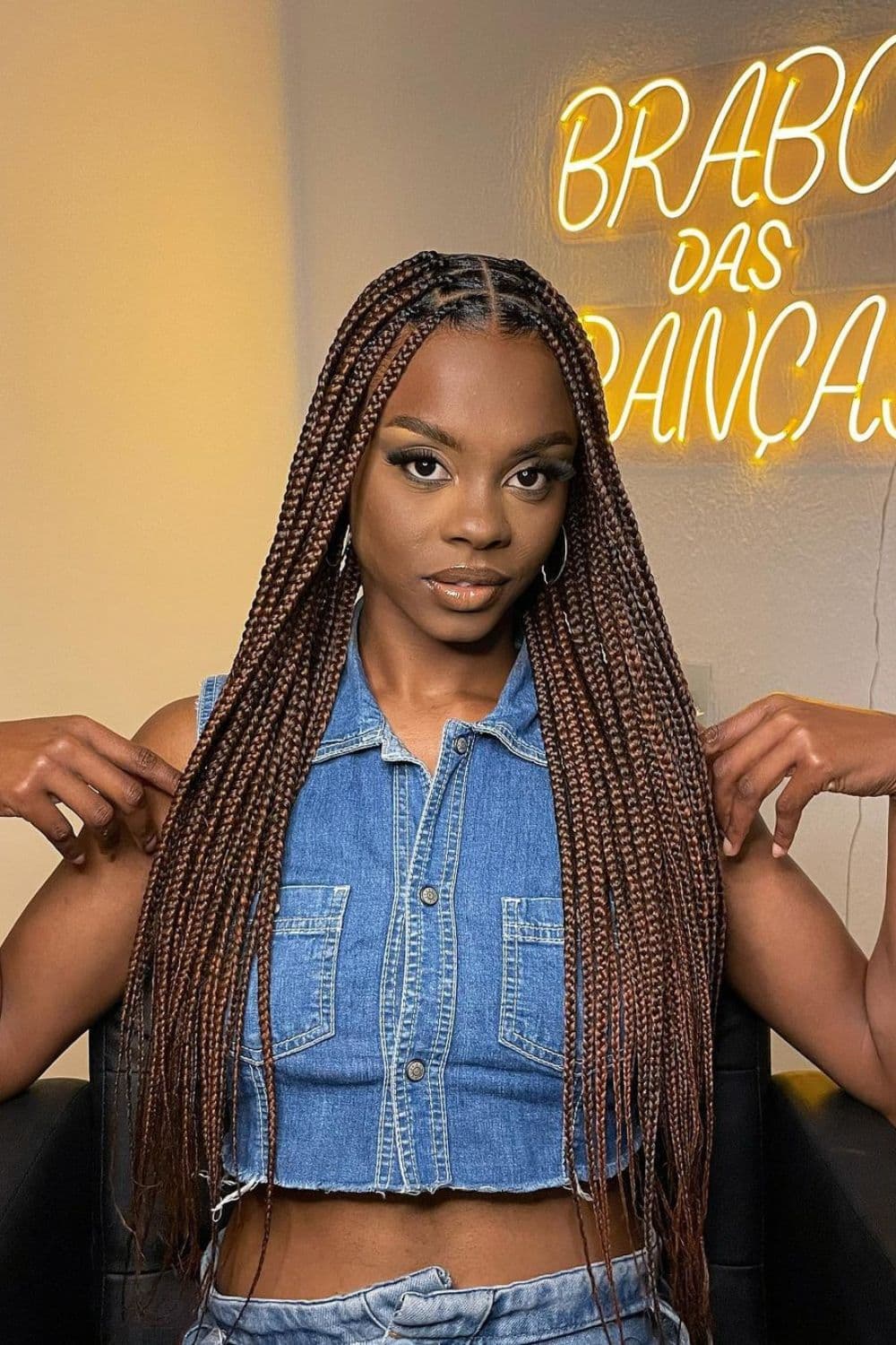 A woman with long dark brown knotless braids.