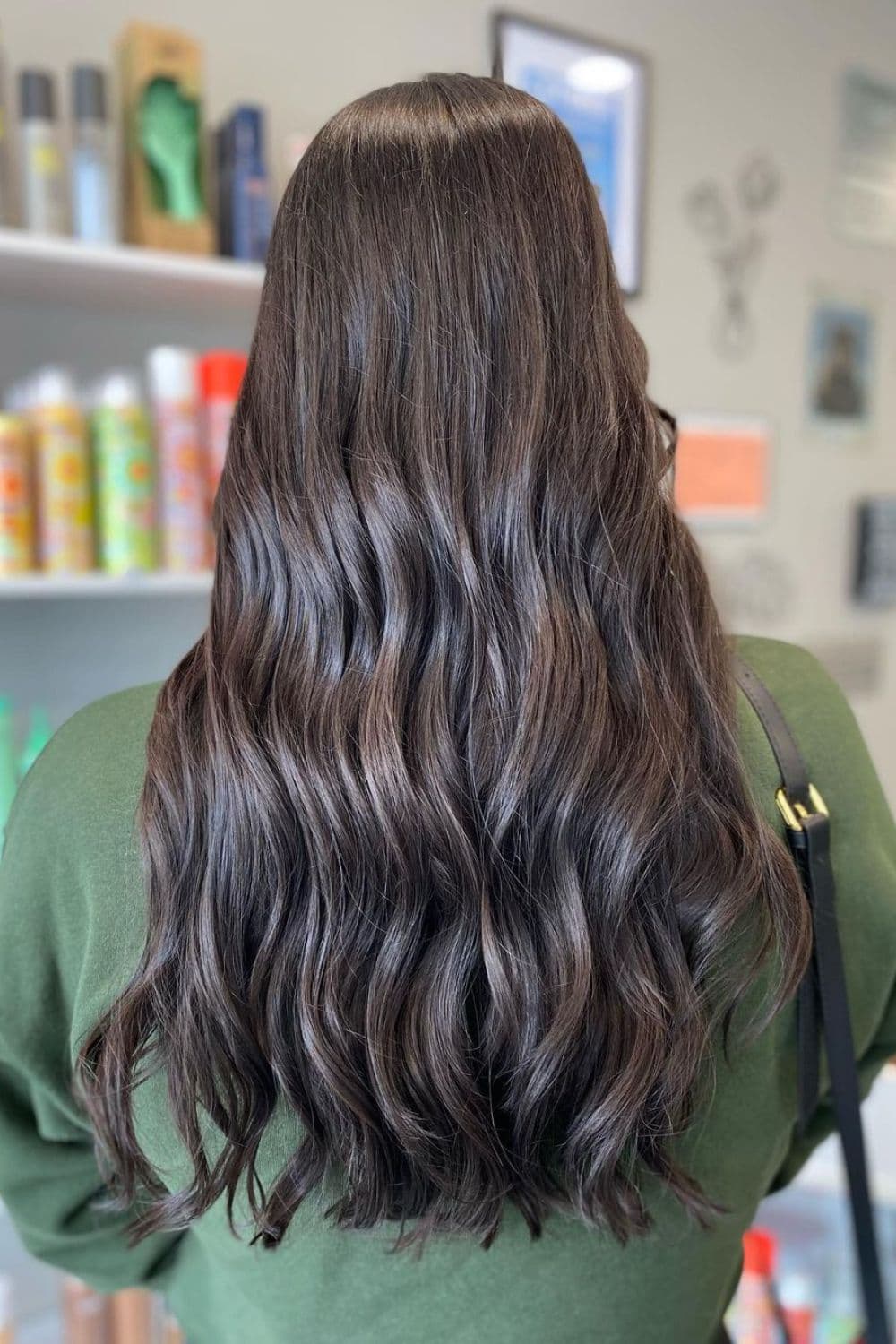 A woman with long wavy dark chocolate brown hair.