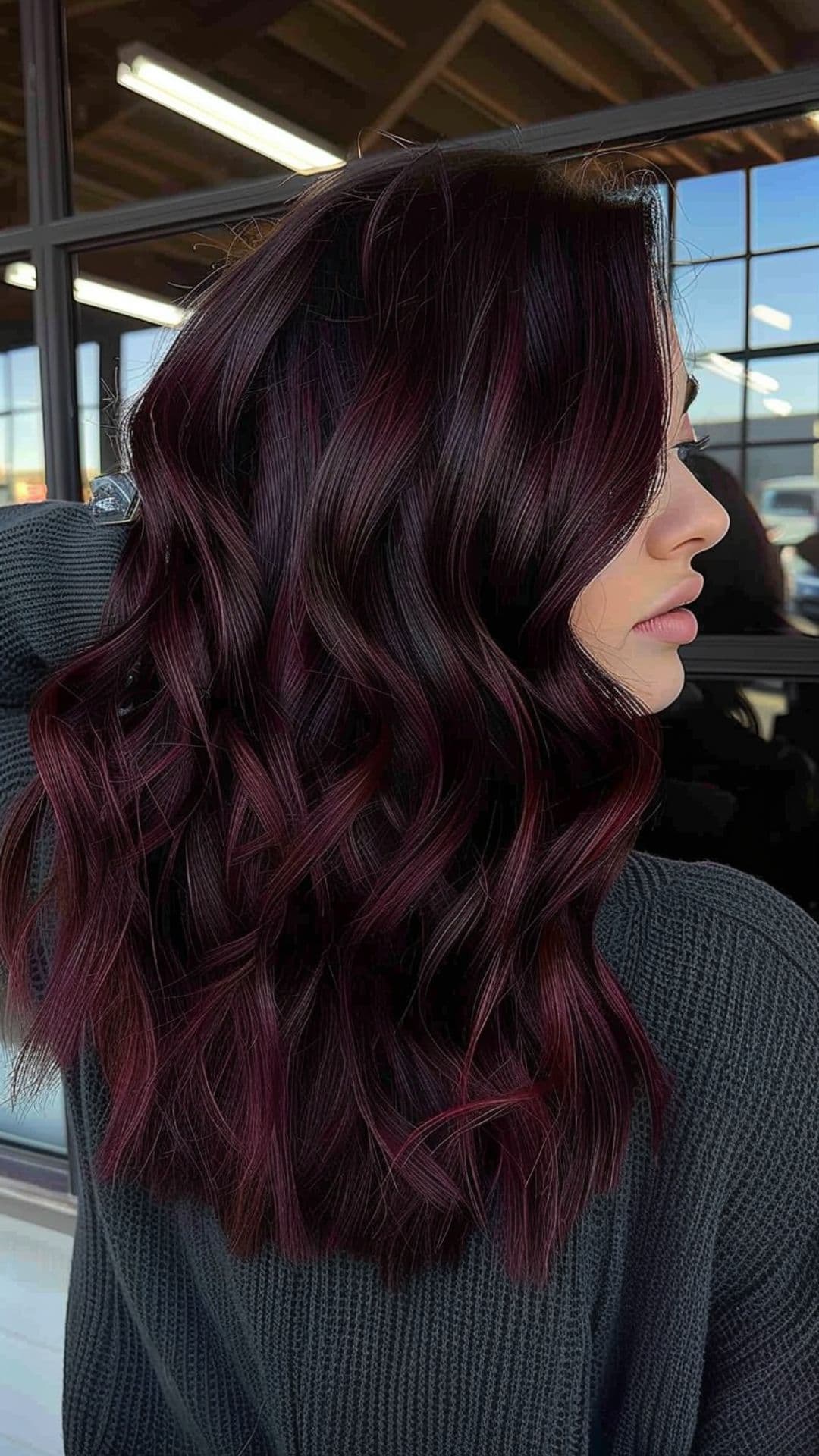 A woman modelling a dark maroon hair.