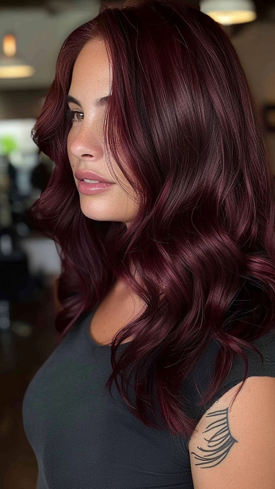 A woman modelling a deep burgundy hair.