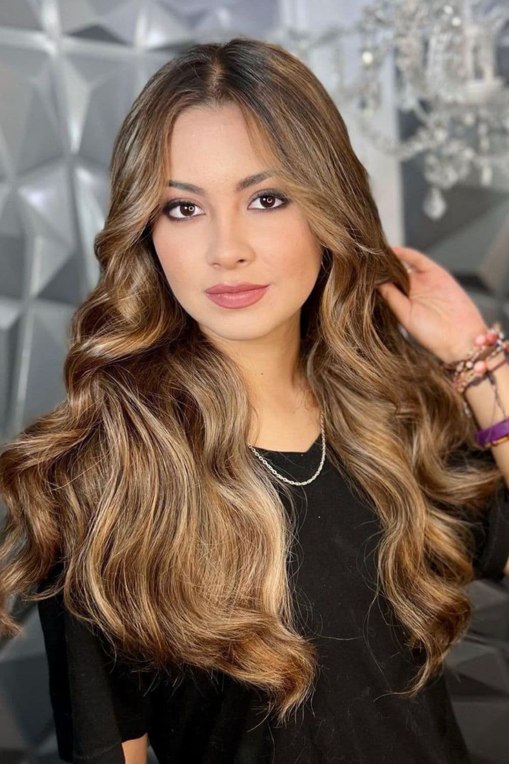 A woman with long wavy dirty brunette hair.