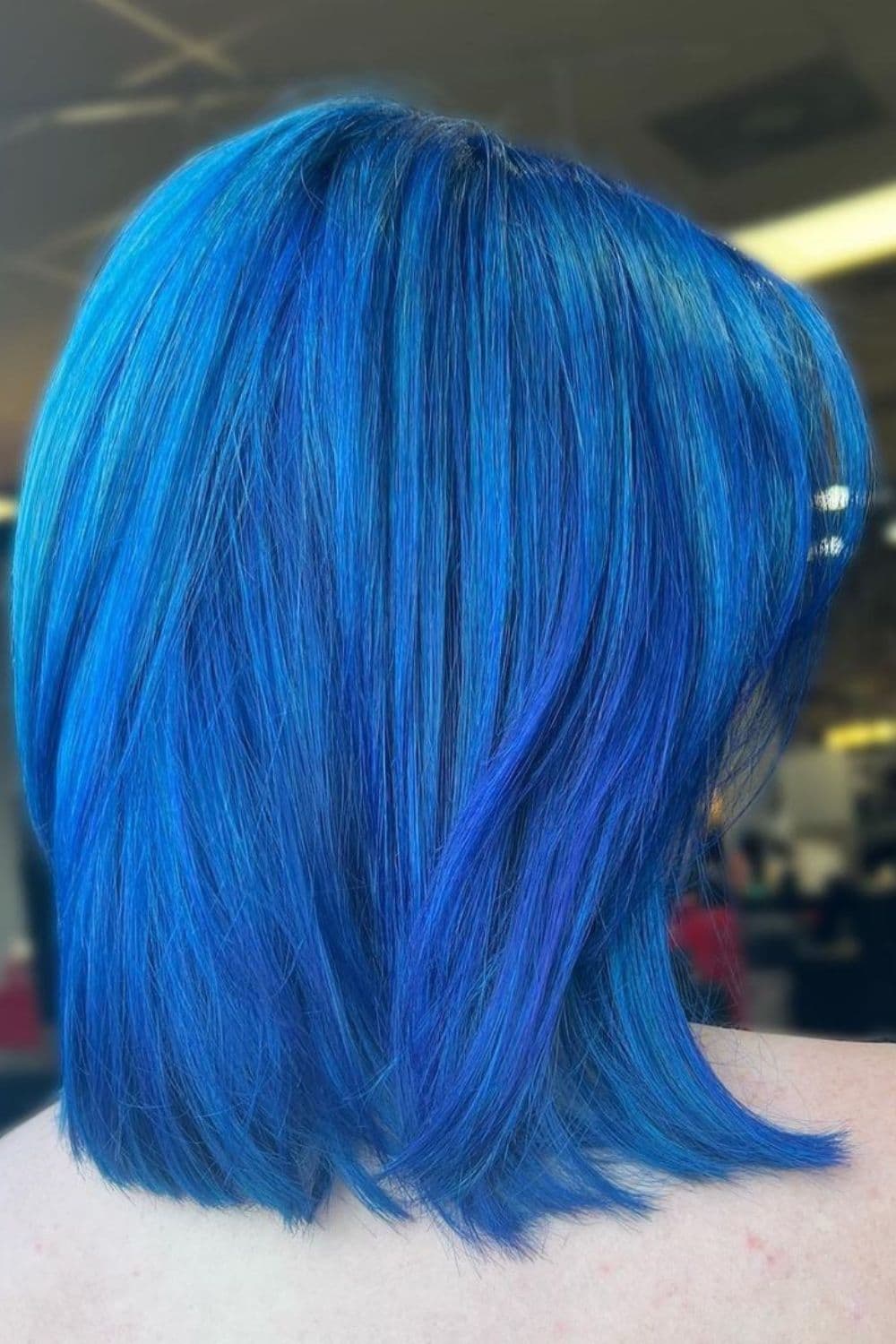 A woman with an electric blue bob cut.