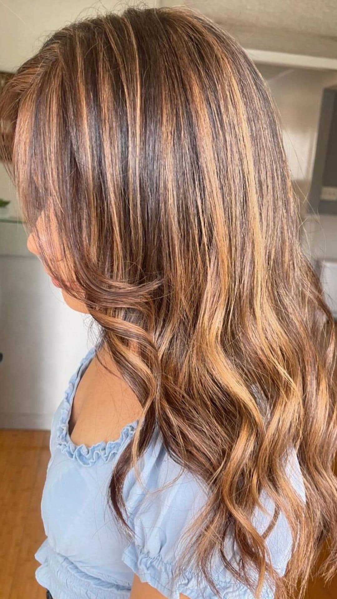 A woman modelling a light sand highlights color melt hair.