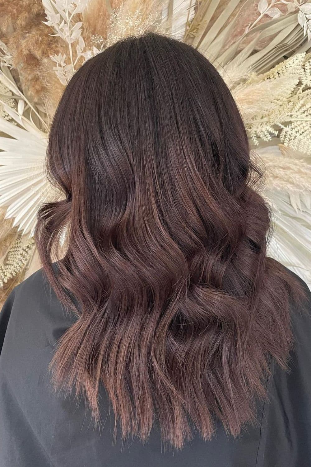 A woman with medium length wavy mocha brown hair.