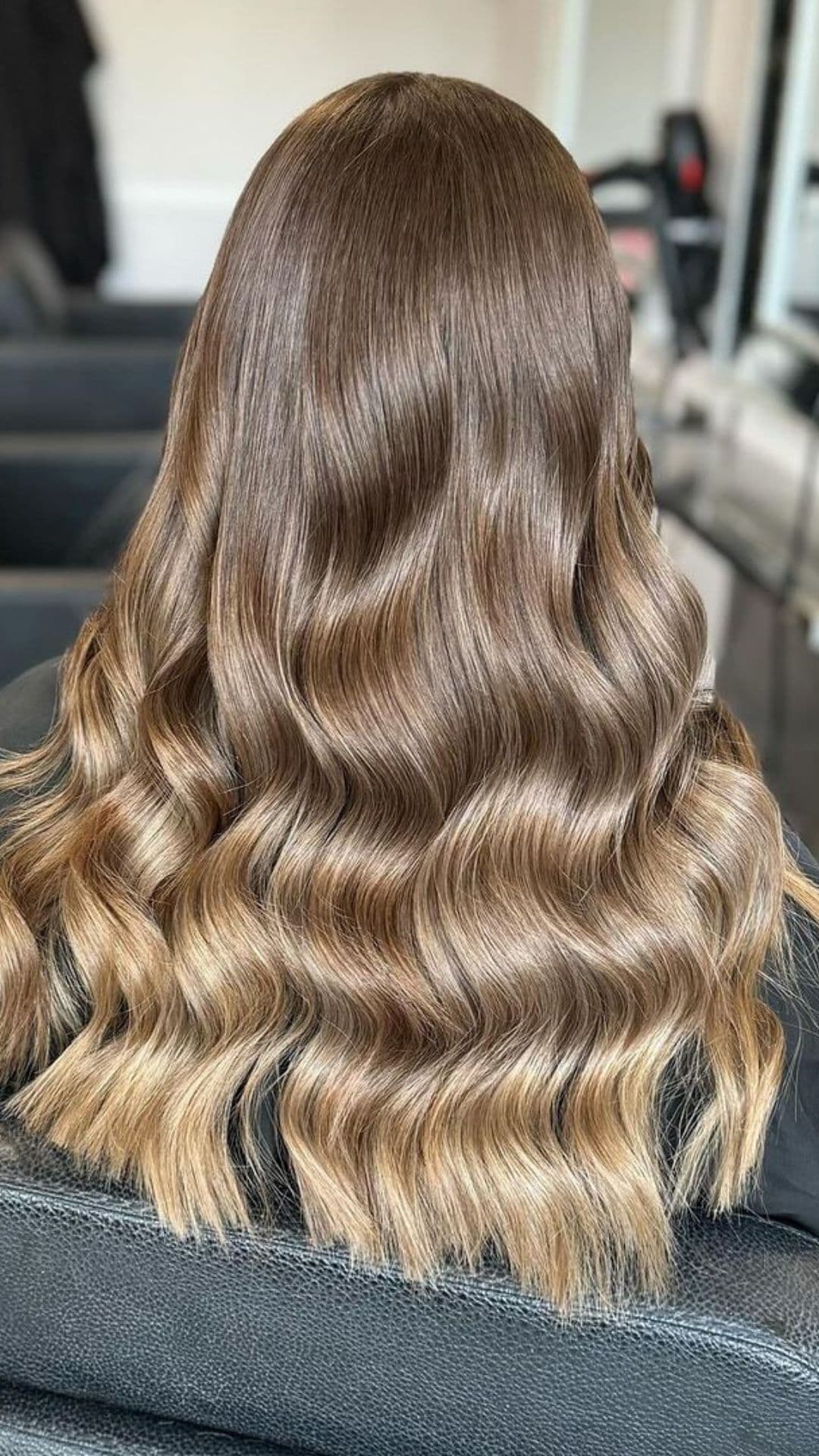 A woman modelling a mushroom brown hair with lighter ends.