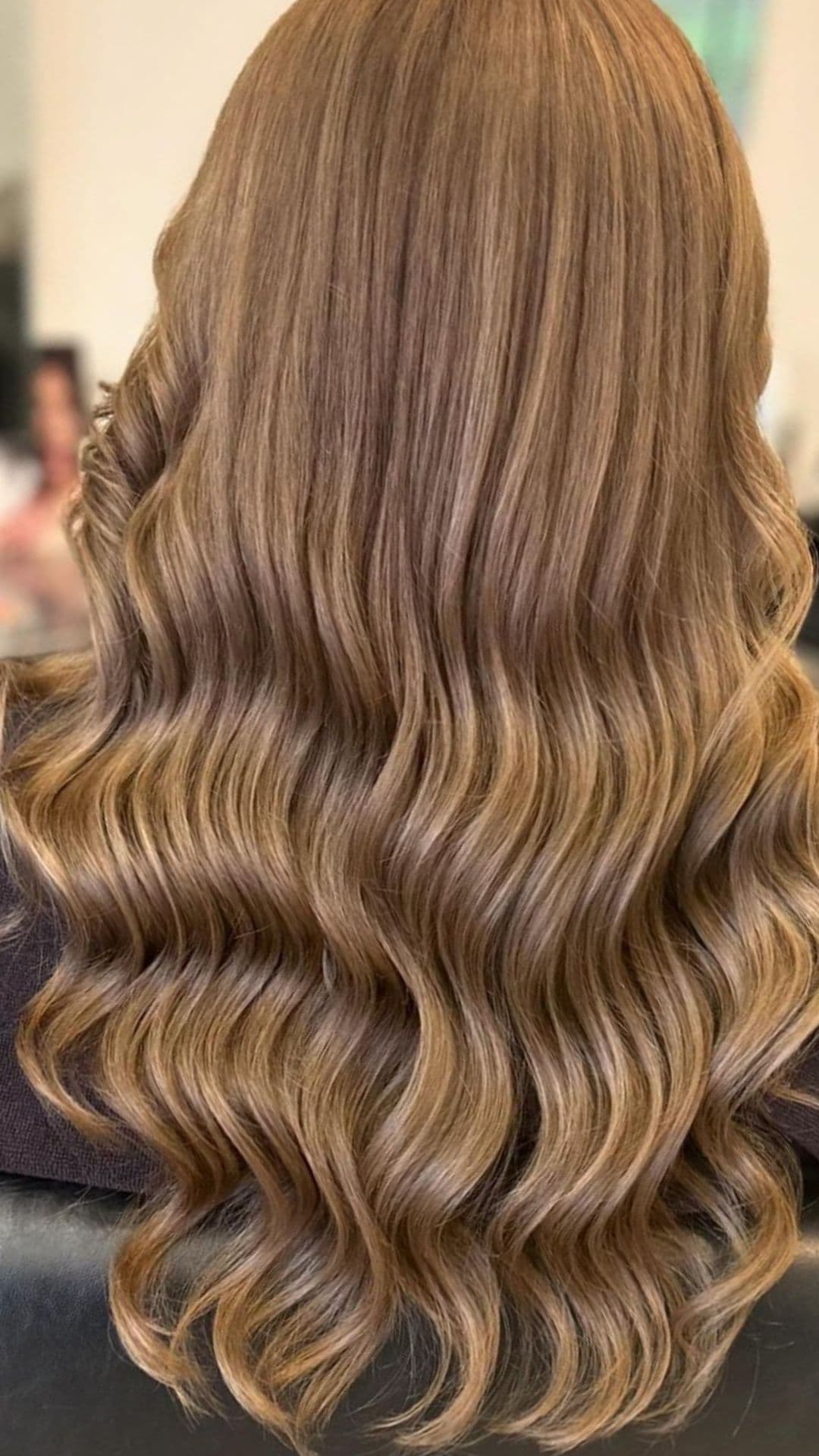 A woman modelling a natural light brown hair color.