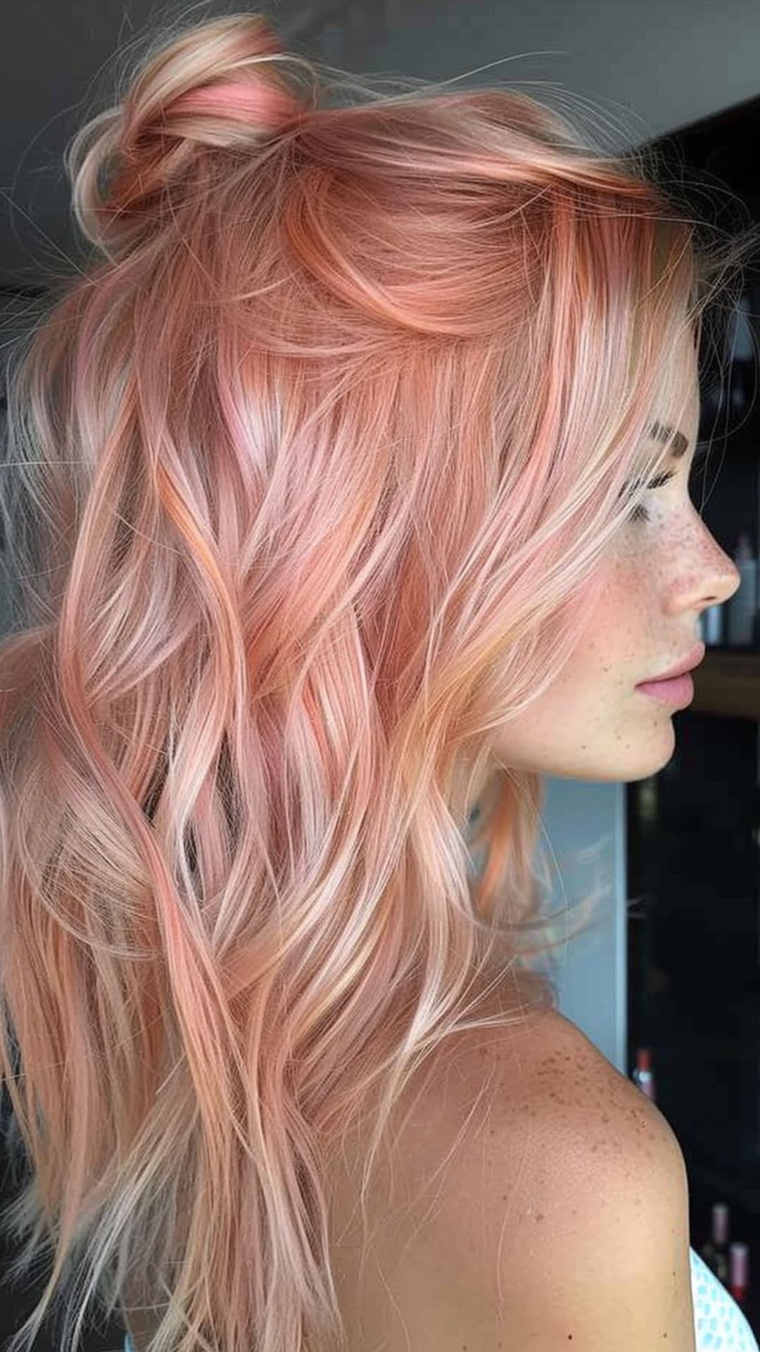 A woman modelling a pastel rose gold hair.