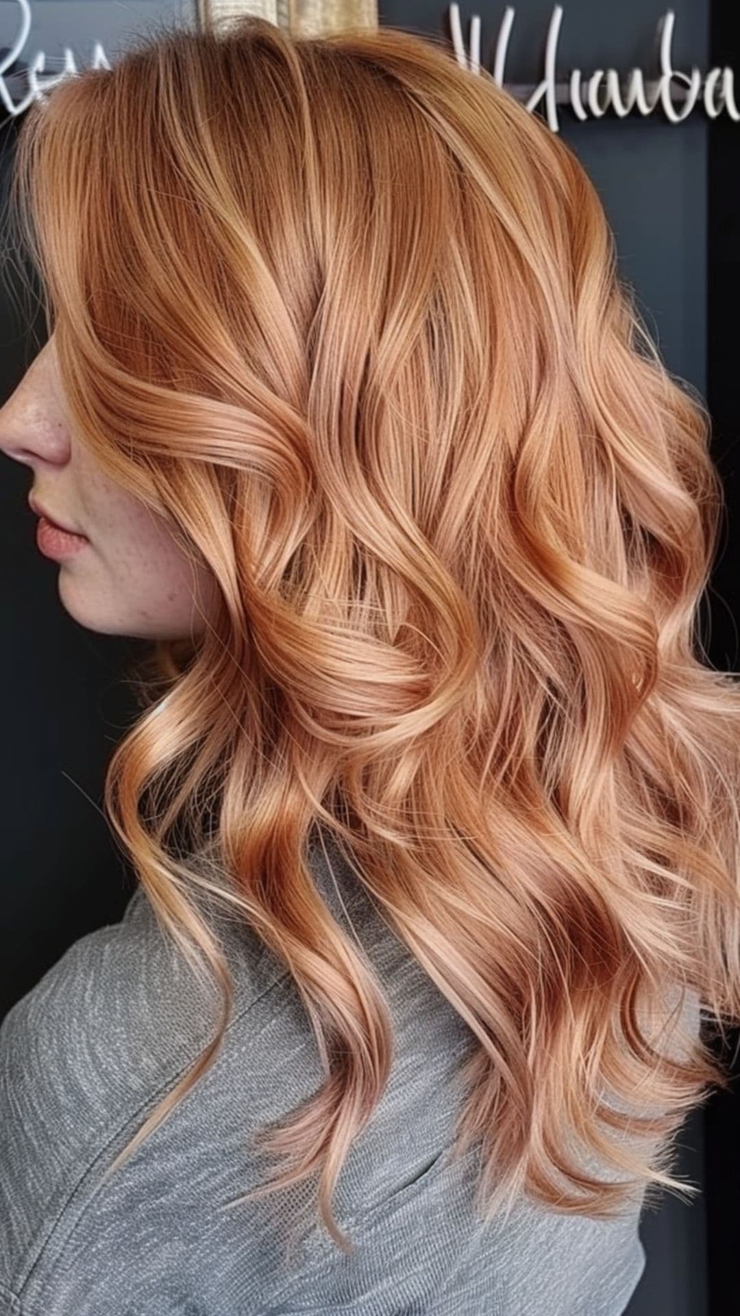 A woman modelling a peachy rose gold waves.