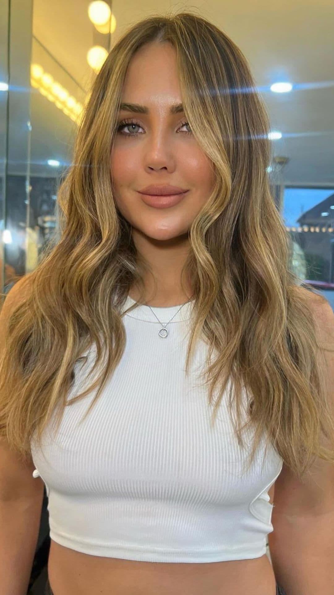 A woman modelling a sandy brown hair.