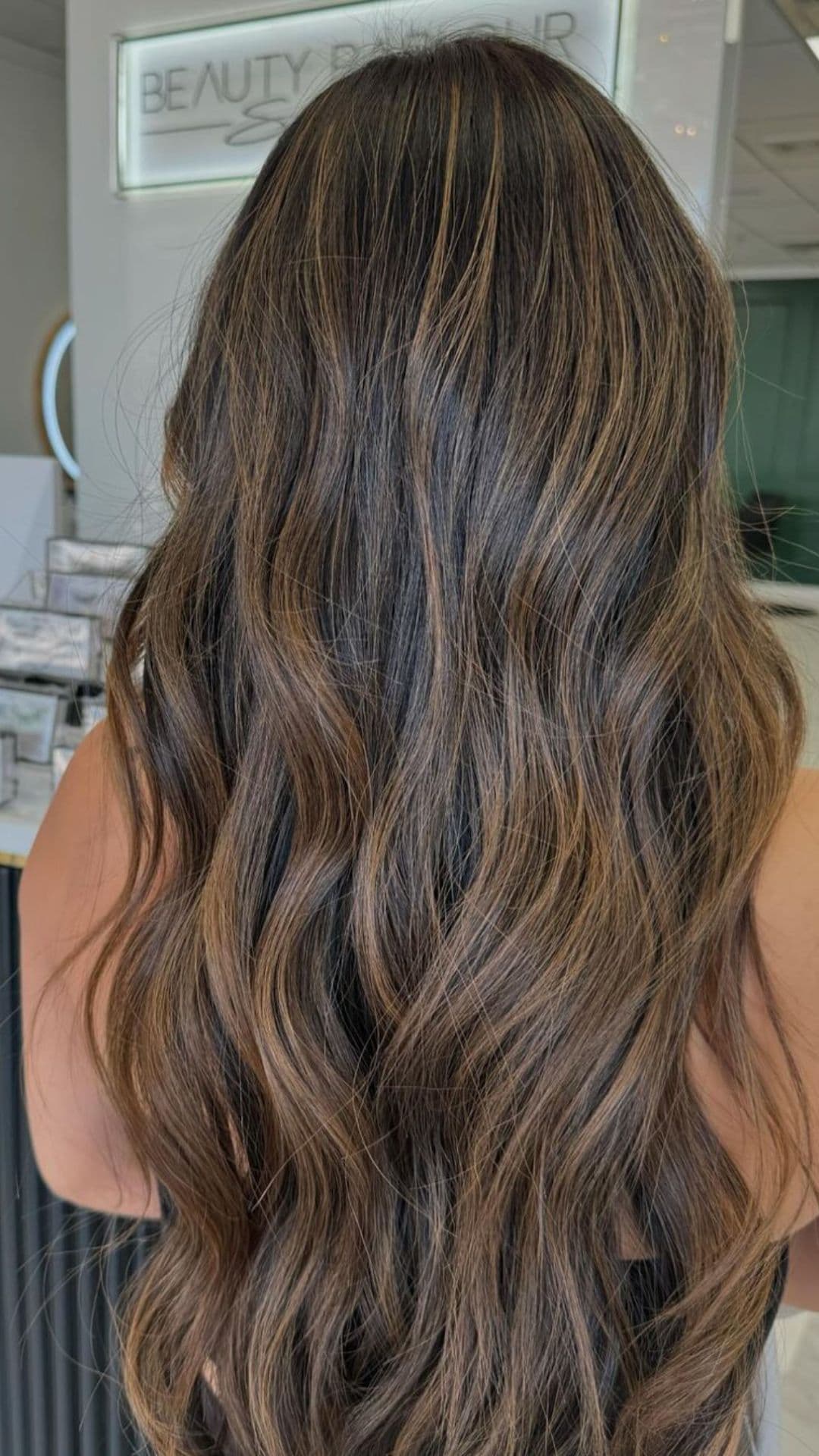 A woman modelling a soft light brown balayage.