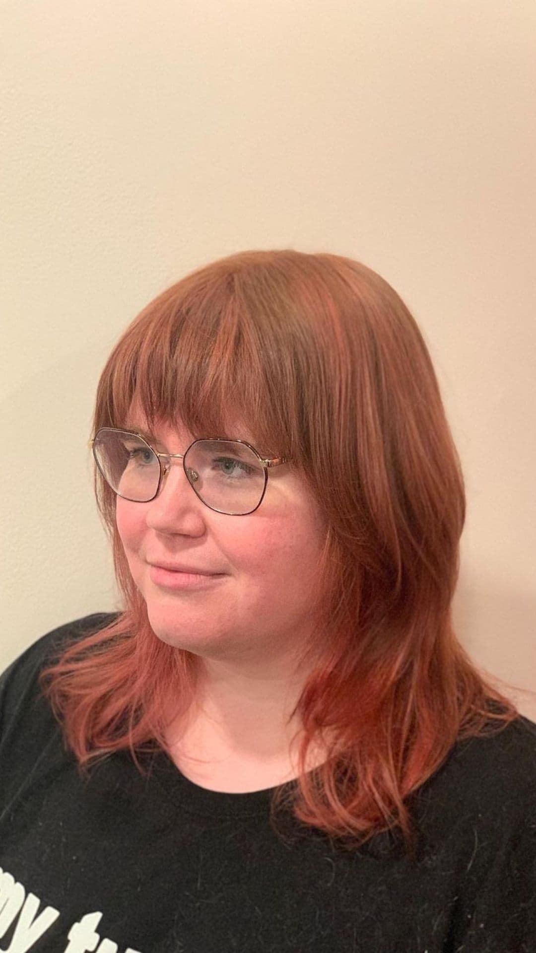 A woman modelling a soft rose gold on a brown hair.