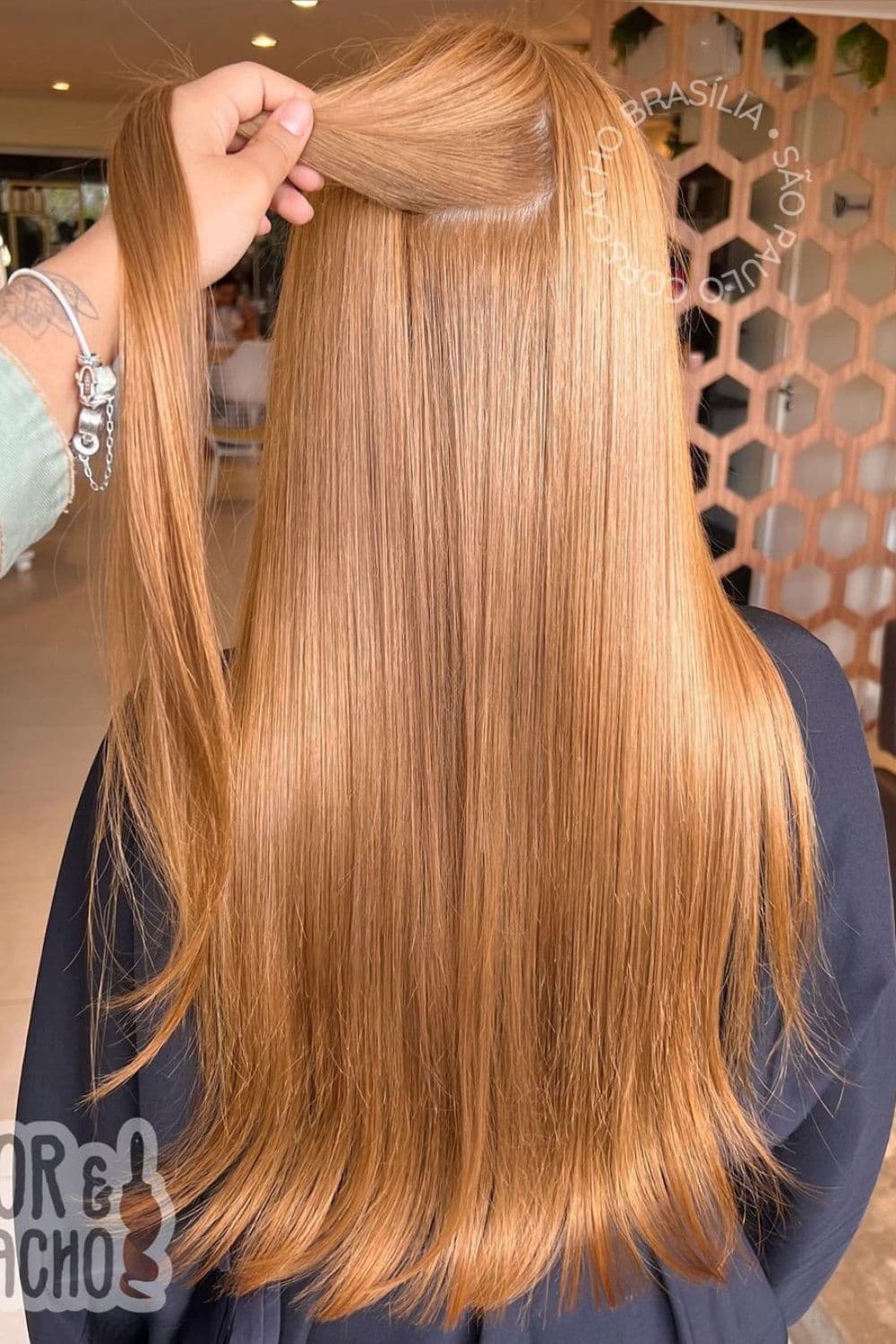 A woman with a long straight strawberry blonde hair.