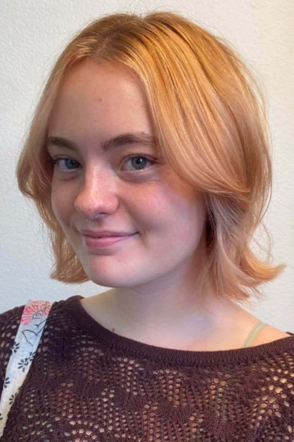 A woman with a strawberry blonde bob.