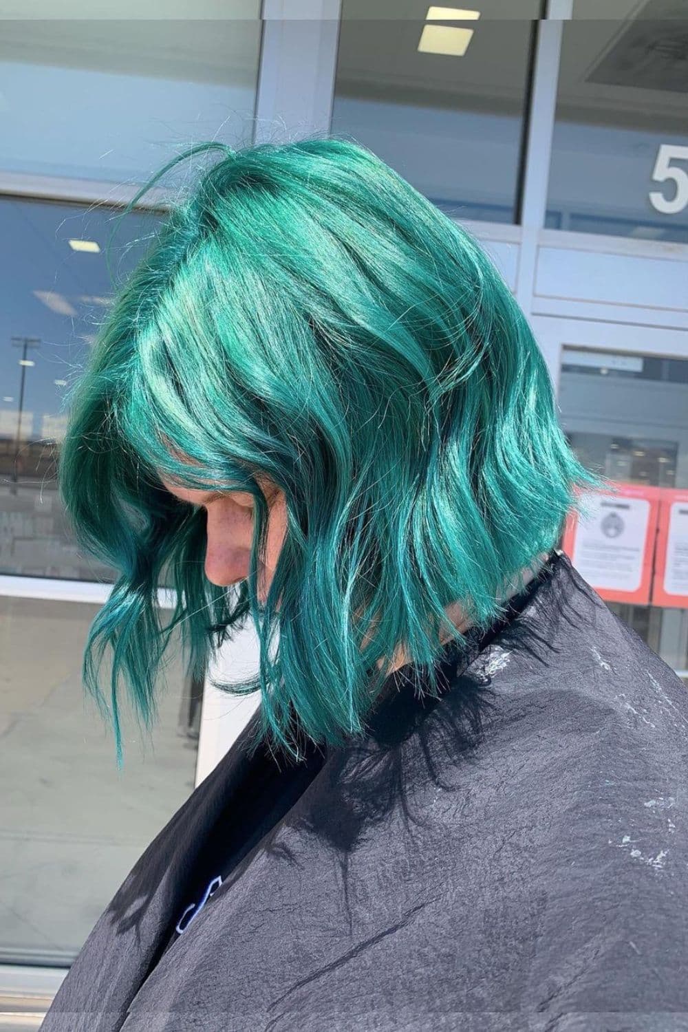 A woman with a teal blue bob cut.